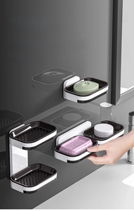 Detail of wall-mounted double-drawer soap dish with drainage trays in black and white finish