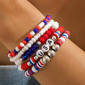 Close-up of patriotic beaded bracelets with red, white, blue beads and USA letter charms