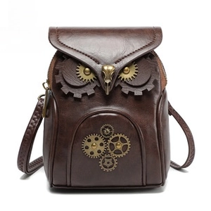 Detailed view of steampunk owl bag with metallic gears and brown leather texture