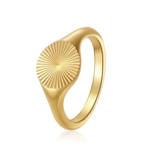 Detail shot of a gold signet ring featuring a radial sunburst pattern and polished finish