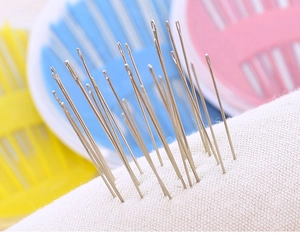 Macro shot of stainless steel sewing needles piercing through a white textured fabric