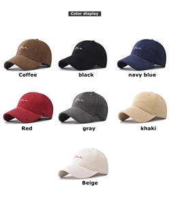 Detail view of cotton baseball caps showing diverse colors and me cursive embroidery