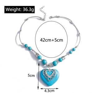 Detail showing oversized turquoise heart pendant with dimensions 5x4.3cm and viking pattern