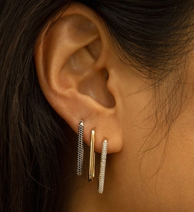Detail showing gold plated and micro-paved rectangular hoop earrings on model