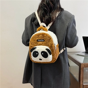 Rear view of brown and white plush panda backpack on model showing strap fit