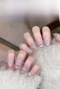 Detail of pink cat eye press-on nails with luxury pearls and sparkling diamond accents