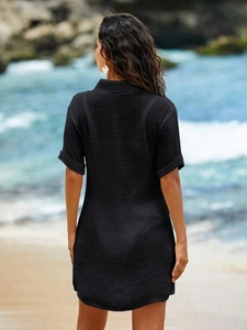 Detail view of black textured beach cover-up featuring a crinkled fabric and loose fit