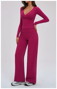 Close-up of rose red yoga set with V-neck long sleeve top and high waist wide leg pants