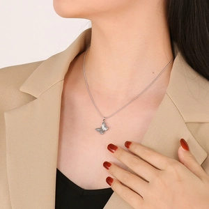 Detail of silver butterfly pendant necklace with delicate snake chain on neck