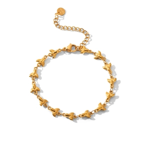 Detail view of gold-plated stainless steel bracelet with bee charms and extension chain