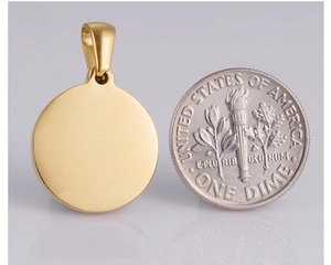 Polished gold-plated round pendant back view next to a coin for size reference