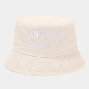 Close-up of white 3D Swiftie Est. 1989 embroidery on cream cotton bucket hat fabric