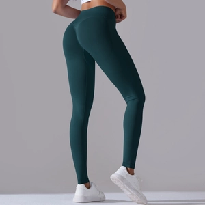 Close-up of seamless dark green yoga pants with ruched peach lift and V-cross high waistband