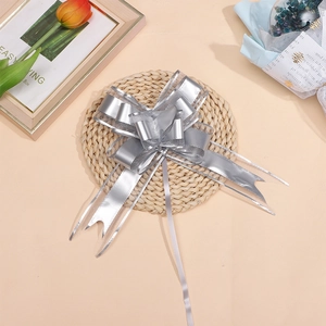 Close-up of matte silver snow yarn ribbon bow with metallic luster for gift packaging