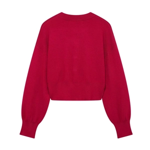 Back view of a vibrant magenta knit cardigan with ribbed cuffs and drop shoulder design