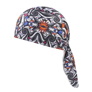 Close-up of elastic paisley bandana with orange sun eye patterns and durable edge stitching