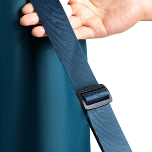 Detail of adjustable shoulder strap and plastic buckle on blue yoga mat bag