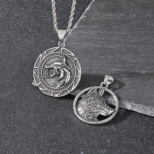 Detailed view of vintage viking wolf head pendants with intricate nordic rune engravings
