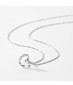 Close-up of s925 silver irregular heart necklace with sparkling crystals on white background