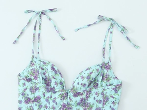 Close-up of blue floral print cotton fabric with adjustable shoulder strap details