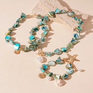 Set di gioielli stile mare con ciondoli a stella marina, conchiglie e perle su pietra