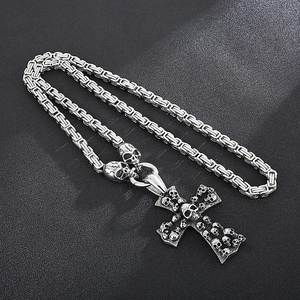 Detailed view of silver cross skull pendant with unique rectangular link steel chain