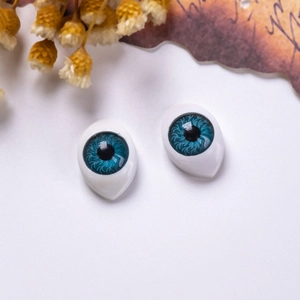 Detailed view of 12x16mm blue boat-shaped acrylic doll eyes with realistic iris texture
