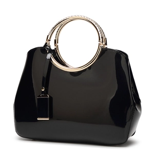 Elegant black patent leather shoulder bag with gold braided ring handles for brides