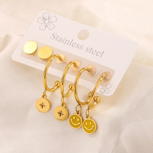 Macro shot of 18K gold plated stainless steel earring set with enamel smiley face charms