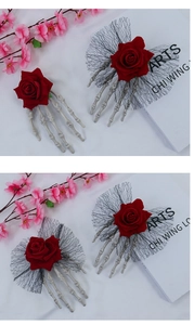 Detail view of gothic skeleton hand hair clip with red rose and black lace mesh