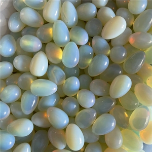 Macro view of pile of stacked oval opal gemstone eggs with rainbow luster effect