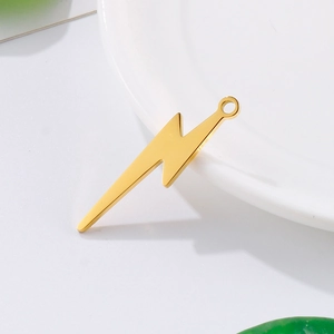 Golden lightning bolt pendant in stainless steel for DIY jewelry making on white tray