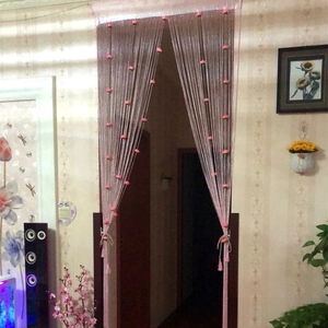 Close-up of pink heart tassels and silver thread fringe curtain for room decor