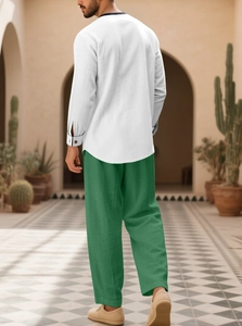 Men's resort set featuring white henley shirt and green linen trousers from a back view
