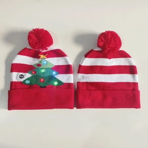 Detail of Christmas knit hats showing the LED light battery switch and knit texture