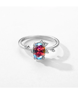 Macro shot of silver ring featuring a large oval multicolored zircon and diamond accents
