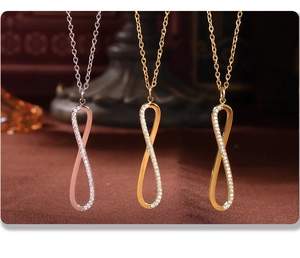 Detail of infinity pendant necklaces with pave cubic zirconia in three metallic finishes
