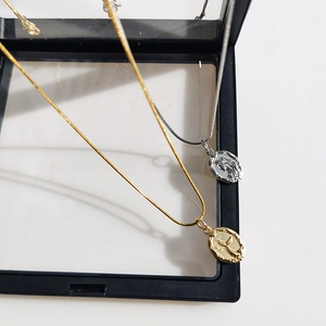 Double-sided mermaid relief pendant necklace with gold and silver snake chain design
