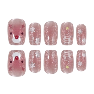 Christmas reindeer press-on nails with pink glitter, snowflakes and festive tree patterns
