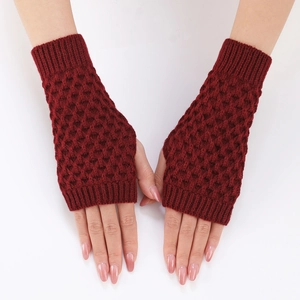 Close-up of wine red knitted fingerless gloves with honeycomb texture on wrists