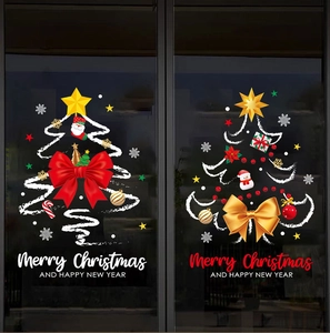 Detail of Christmas window stickers featuring Santa, trees and red bows on glass