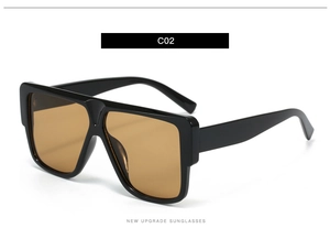 Detail view of square oversized sunglasses with black frames and brown amber lenses