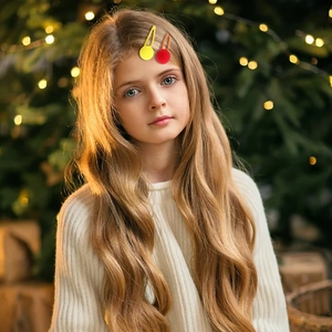 Plush pom pom hair clips for girls in candy colors worn by a model in a festive setting