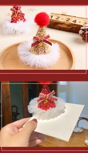 Detail of Christmas sequin mini hat hair clip with mesh veil and festive gold bell