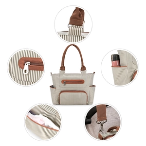 Detail view of 7-piece diaper bag set showing striped canvas fabric and storage pockets