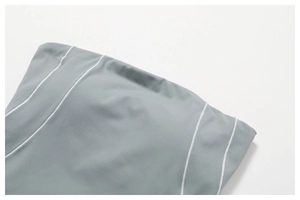 Detail view of high-elastic grey yoga leggings with premium white contrast stitching