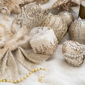 Champagne gold Christmas ball ornaments with glitter bows and Merry Christmas signage