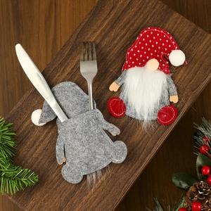 Porte-couverts de gnome de Noël en gris et rouge à pois sur une table en bois rustique