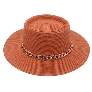 Elegant French style flat top straw hat with gold acrylic chain band in rust orange.