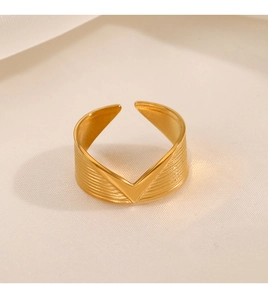 Detailed view of the V-shaped golden adjustable ring featuring a brushed metal texture